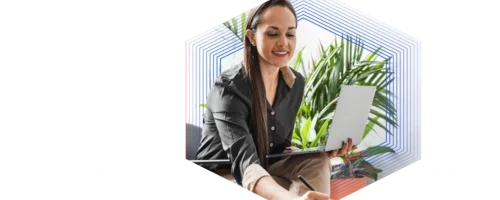 woman on computer with plant